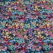Florisse floral print featuring teal, pink, purple, blue and yellow on a dark green background.